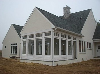Three season porch with Brighton wall panels and divided lite transoms.