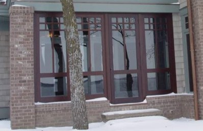 Three season porch with Craftsman style wall panels shown here with glass installed.